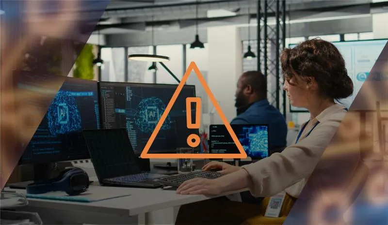 An image to represent the article title: "What's the Risk of Letting Staff Figure Out AI on Their Own?" A woman is sitting at a computer in a busy office. Overlaid on top is an orange error sign.