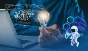 An image of someone sitting at a computer, holding a glowing lightbulb. A glowing diagram with the word AI is coming out of the computer, with an illustration of a little robot. The image is meant to represent the themes of the article around AI adoption and AI strategies for associations.